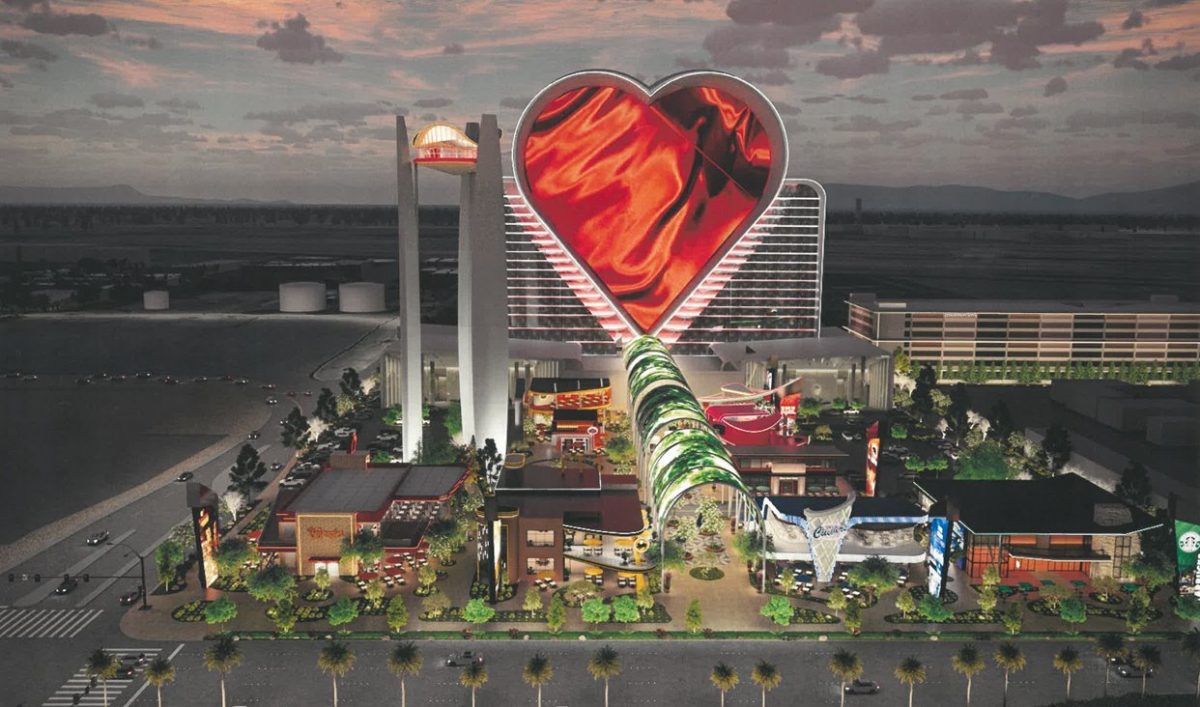 Aerial view of a heart-shaped hotel building with glowing red LED walls on the Las Vegas Strip