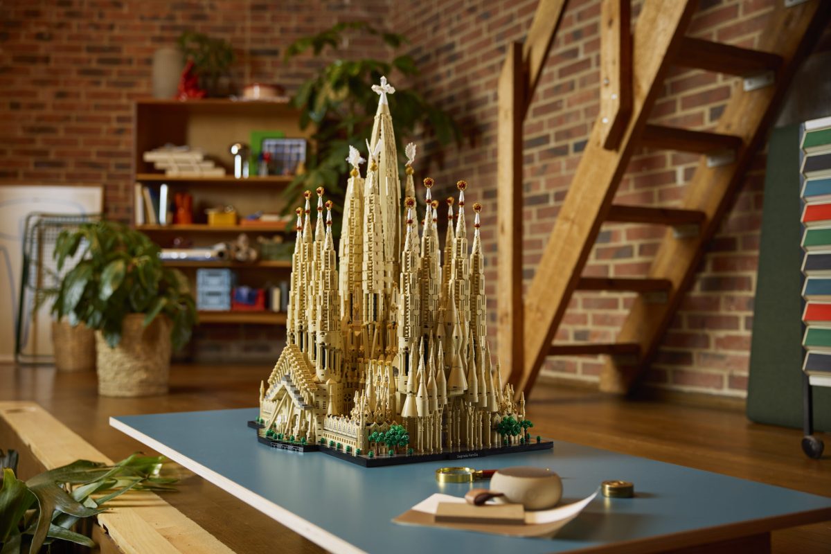 LEGO Sagrada Família model displayed on a blue table in a brick interior