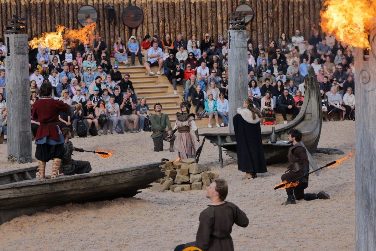 Live-action Roman gladiator performance with fire effects and spectators in amphitheater