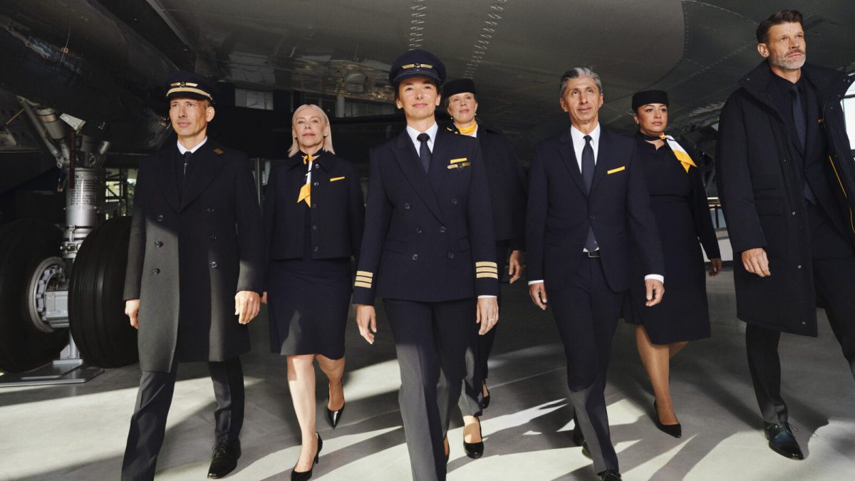 Lufthansa crew members wearing new Hugo Boss uniforms walking through airport terminal