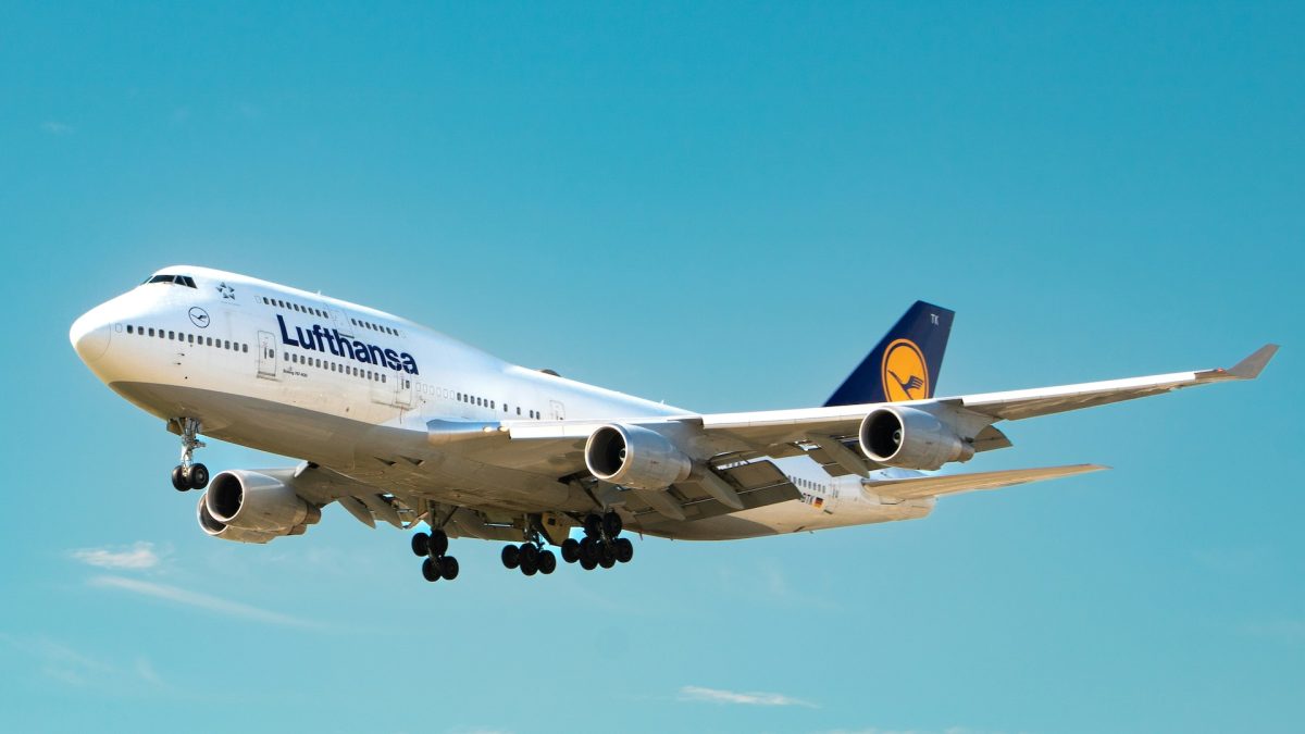 Lufthansa Boeing 747 aircraft in flight against clear blue sky