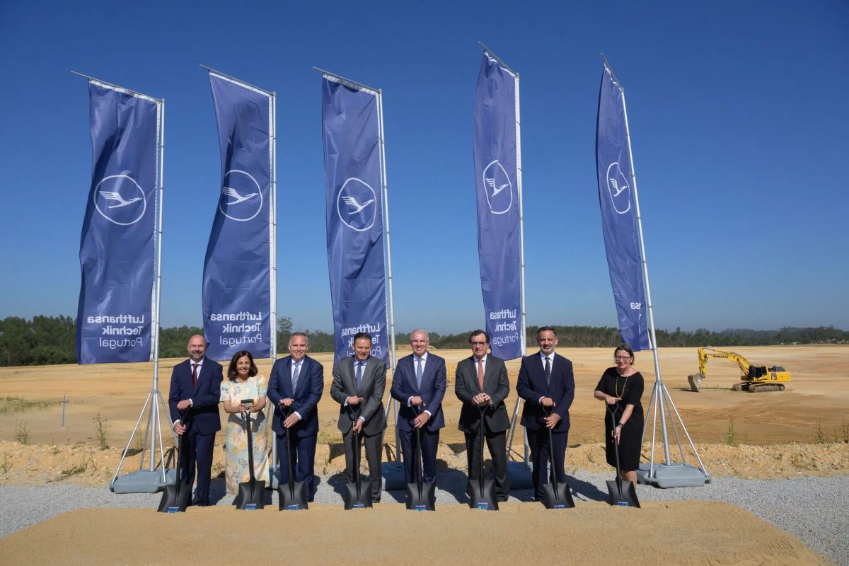 Lufthansa Technik executives at groundbreaking ceremony in Portugal with blue branded flags