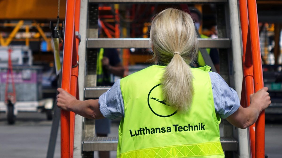 Lufthansa Technik worker climbing ladder in high-visibility vest