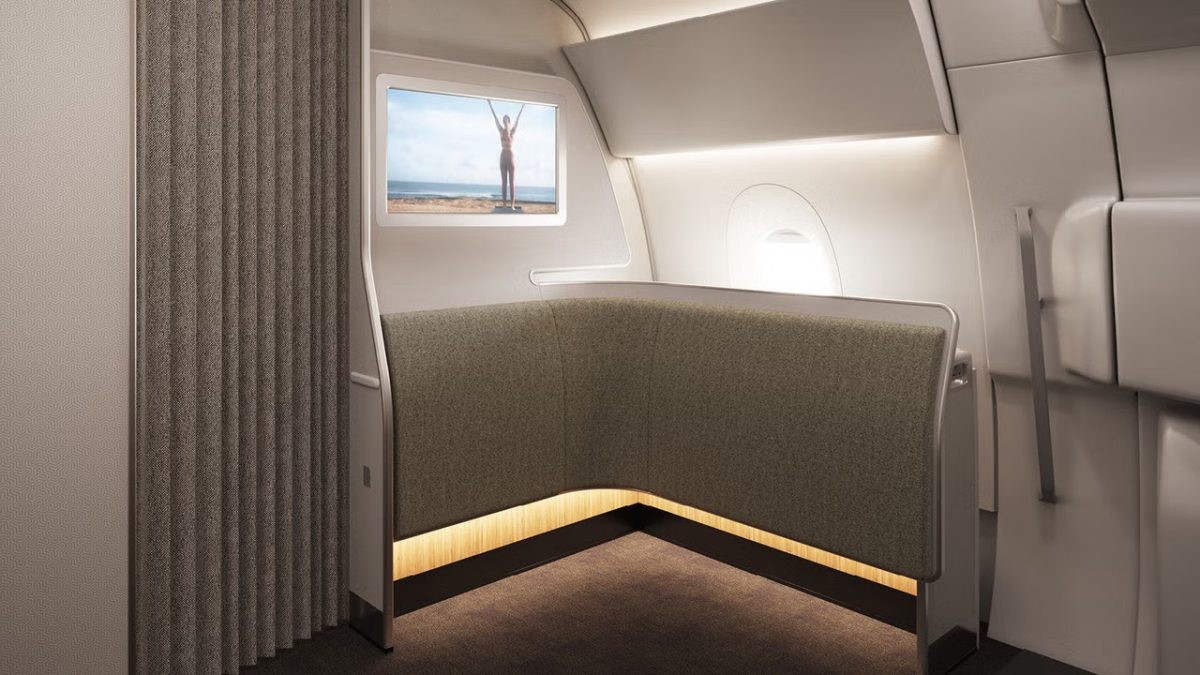 Luxurious airplane cabin interior with a window view of a distant landscape.