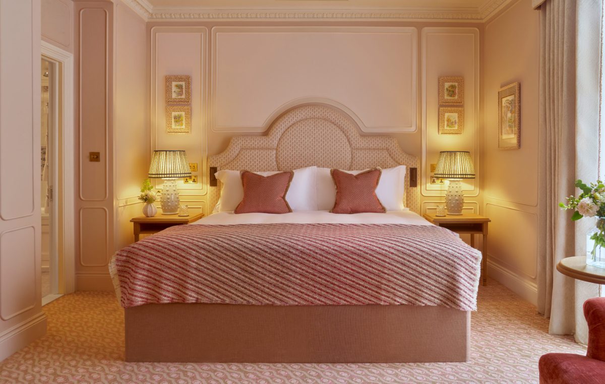 Luxurious hotel room with a plush bed and elegant decor.