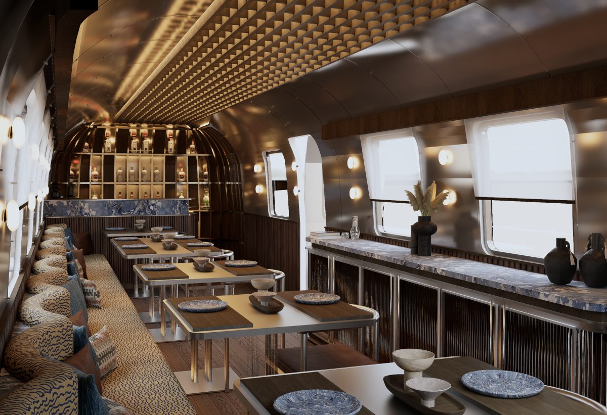 Luxurious interior of a vintage Airstream trailer, styled as a dining space.