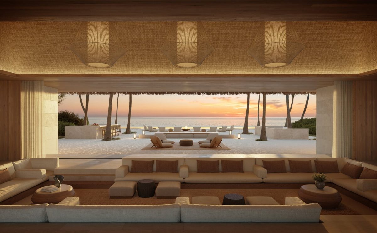 Luxurious Maldivian resort interior with ocean view and sunset.