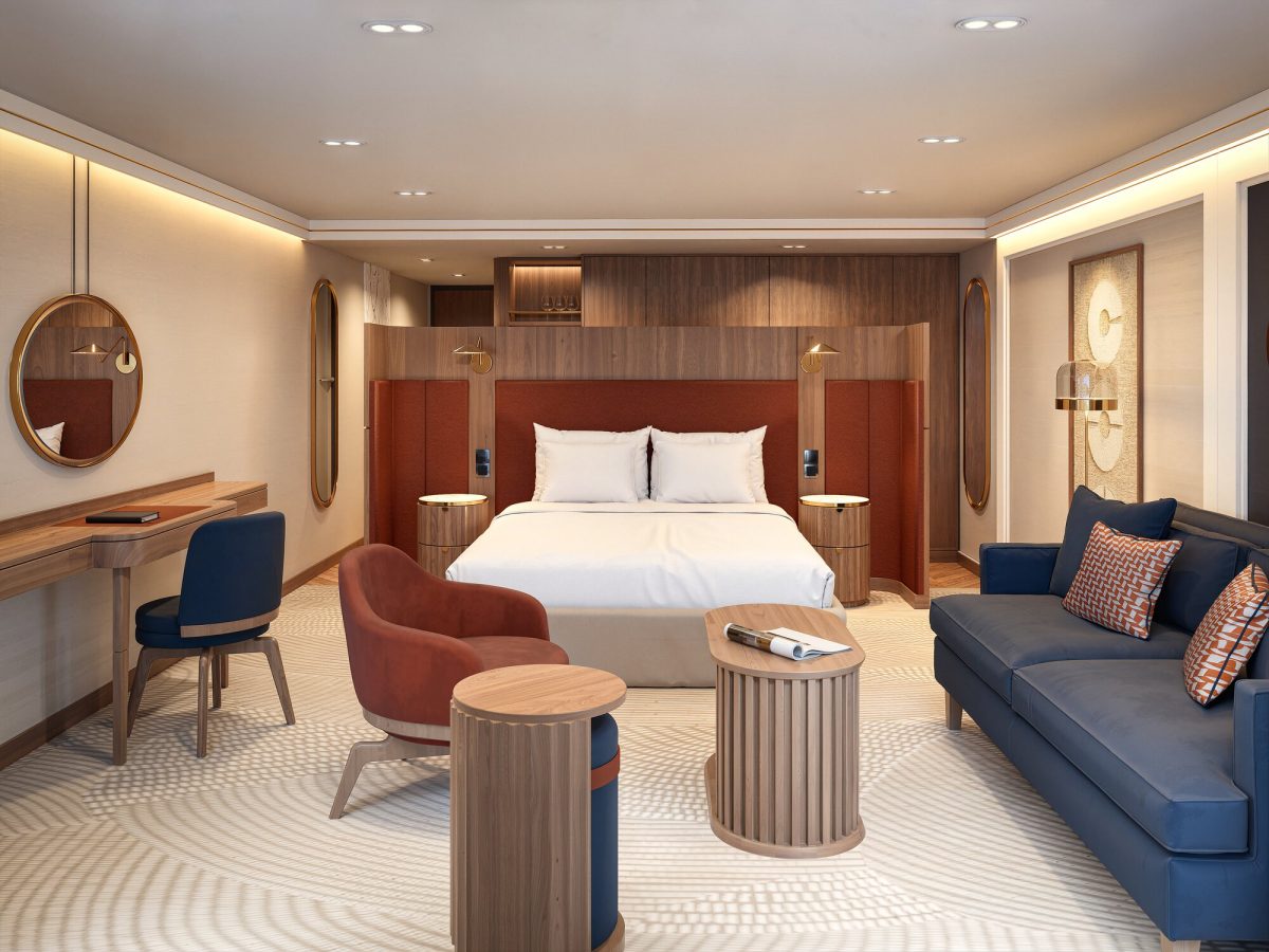 Luxury river cruise ship cabin with king bed, sitting area, and modern amenities