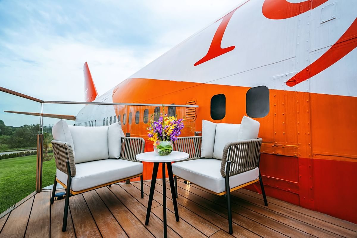 Luxury seating area inside a converted Boeing 747 aircraft with orange and white exterior