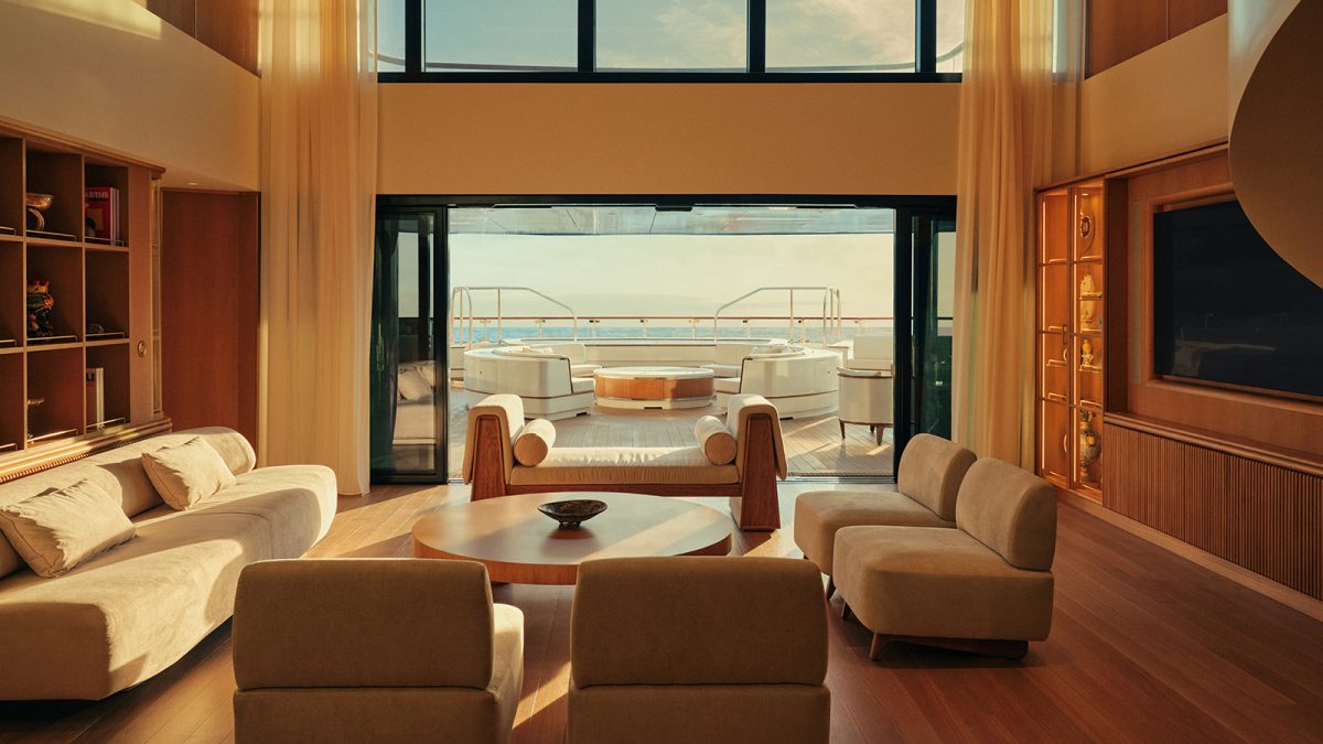 Luxury yacht lounge with floor-to-ceiling windows overlooking Mediterranean waters