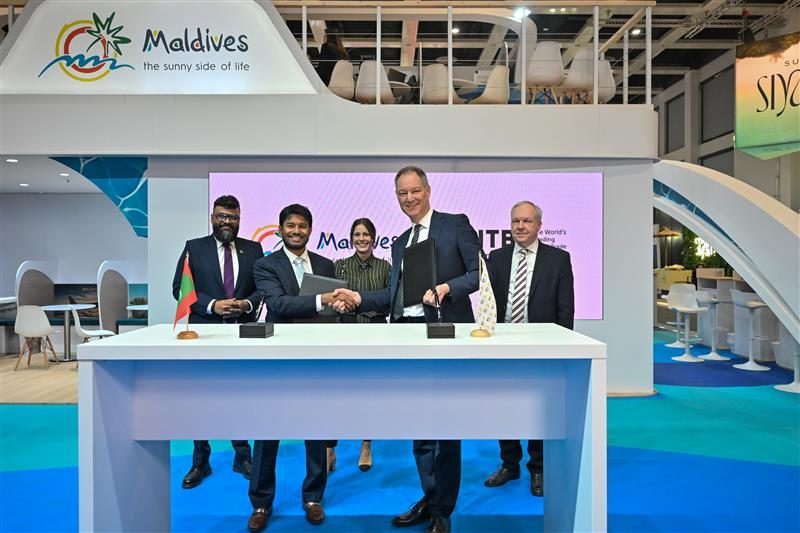Maldives tourism officials at ITB Berlin exhibition booth with blue tropical design