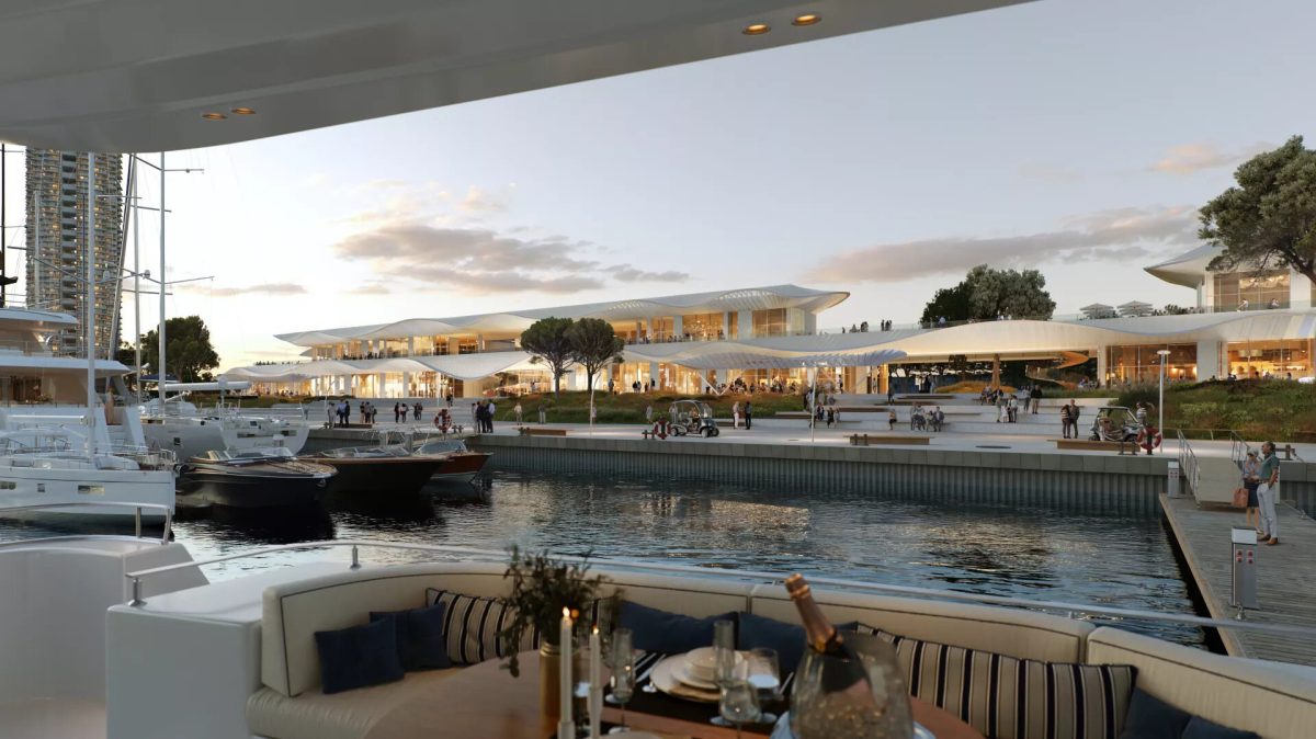 Marina waterfront at The Ellinikon development with modern buildings reflected in calm waters at sunset