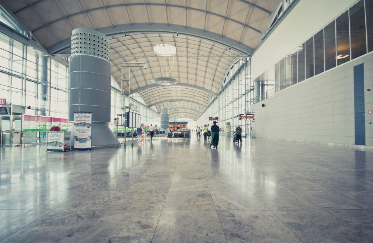 Modern airport terminal with spacious polished floor and arched ceiling