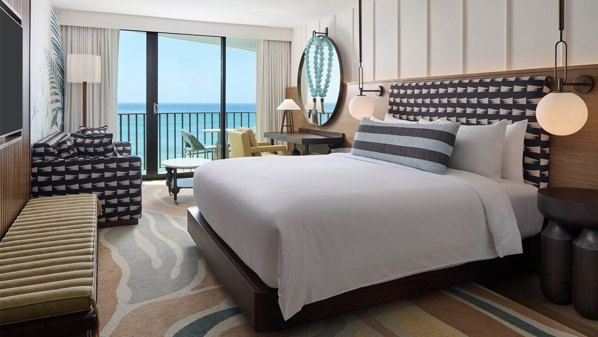 Modern beachfront hotel room with ocean view balcony and contemporary furnishings