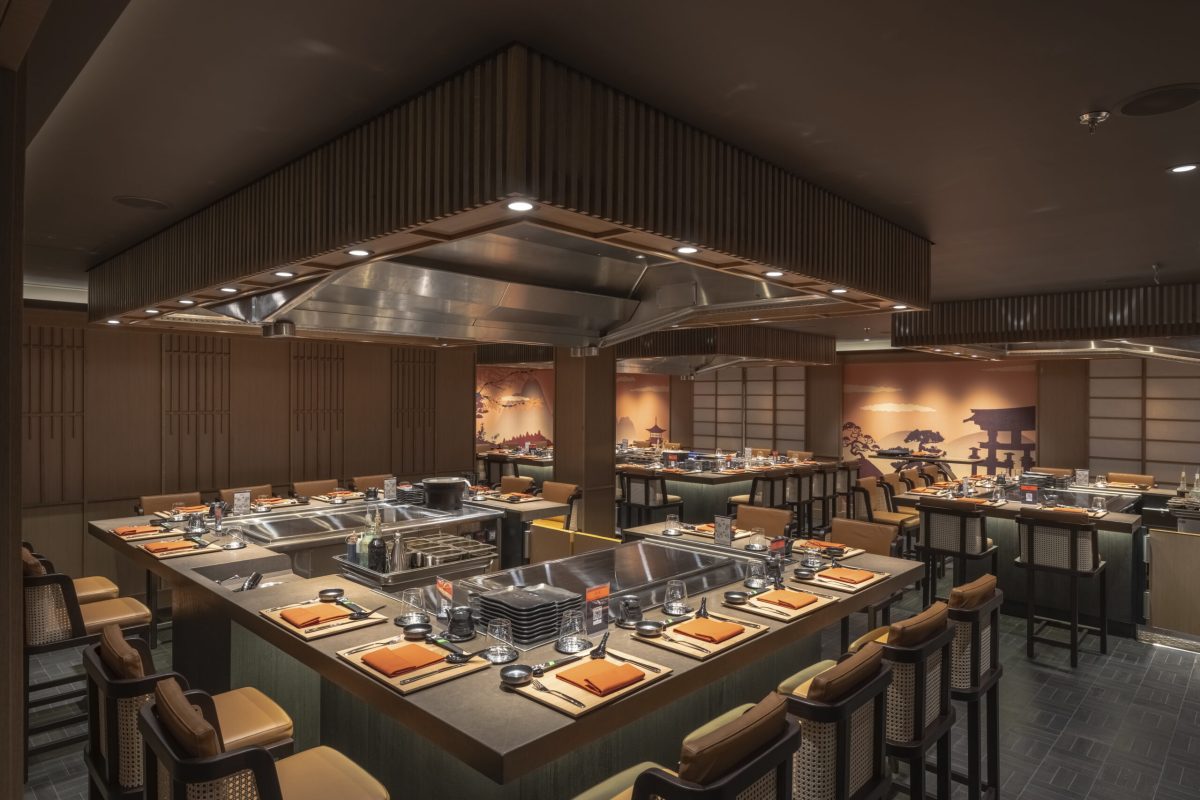 Modern cruise ship dining venue with chef's counter and interactive cooking stations