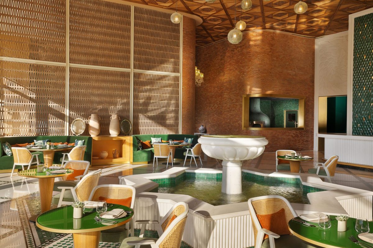 Modern dining area with green accents, wooden elements, and floor-to-ceiling windows at Waldorf Astoria Rabat Salé