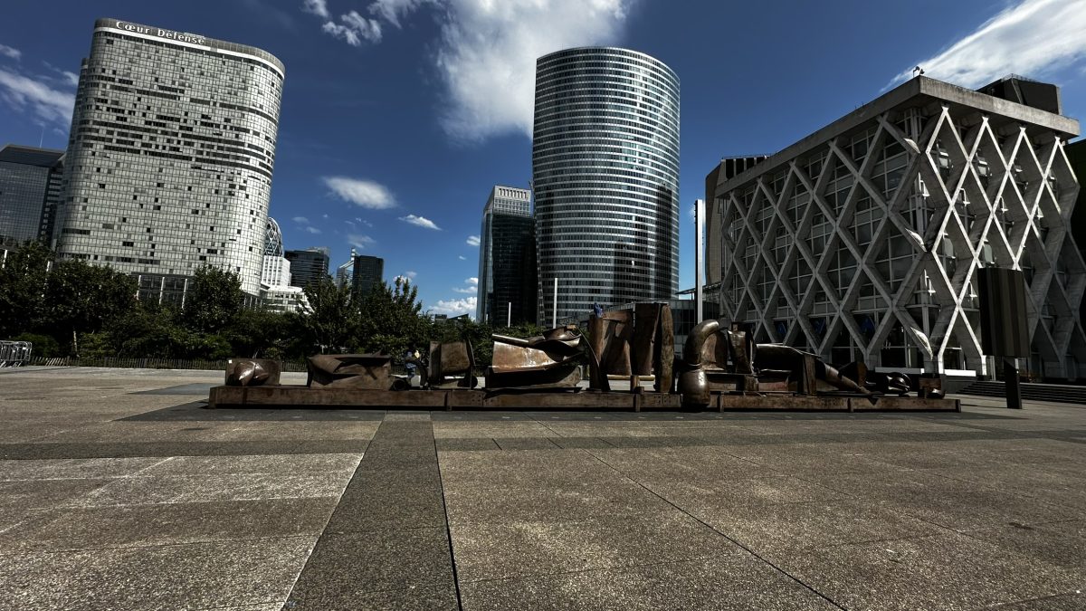 Modern glass and steel skyscrapers surrounding a geometric plaza in Paris