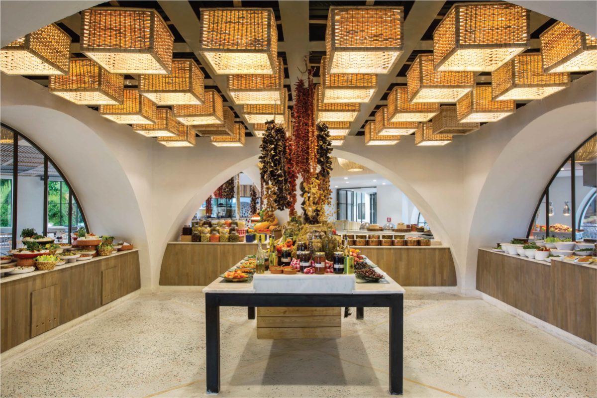 Modern resort interior with sustainable wooden ceiling design and local artisan displays