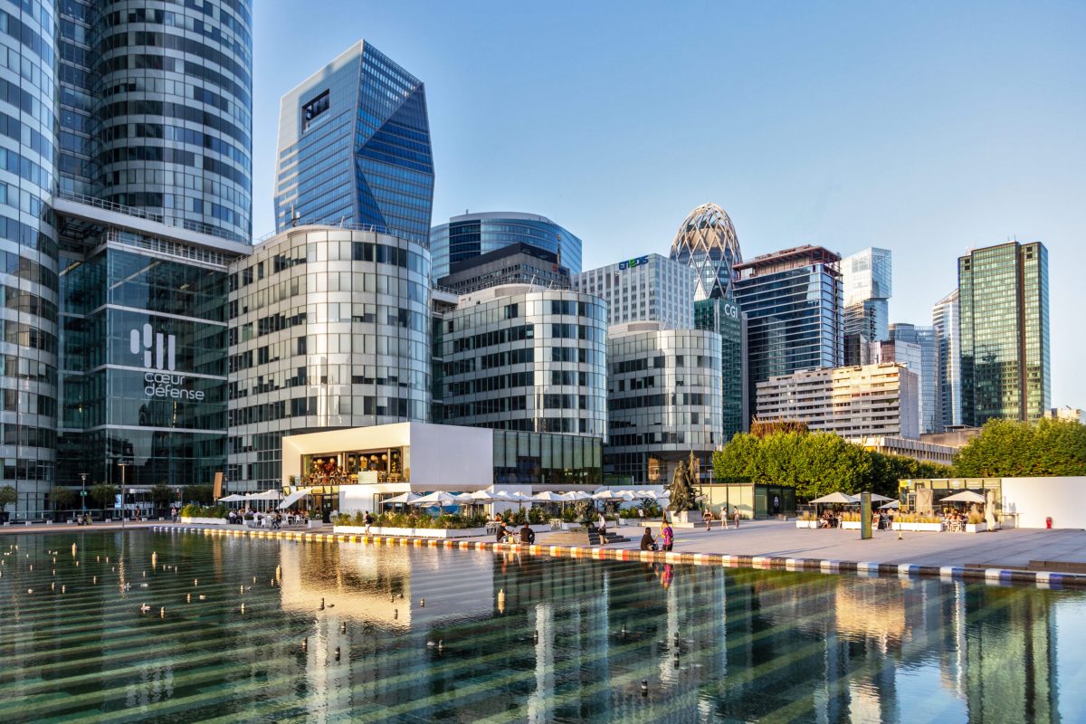 Modern waterfront skyline with contemporary buildings reflected in calm water