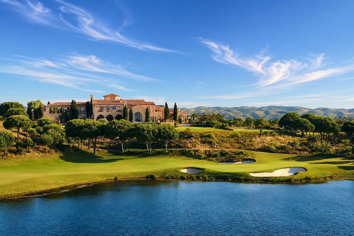 Luxury estate with terracotta buildings overlooking manicured golf course and blue water in Portugal's Algarve