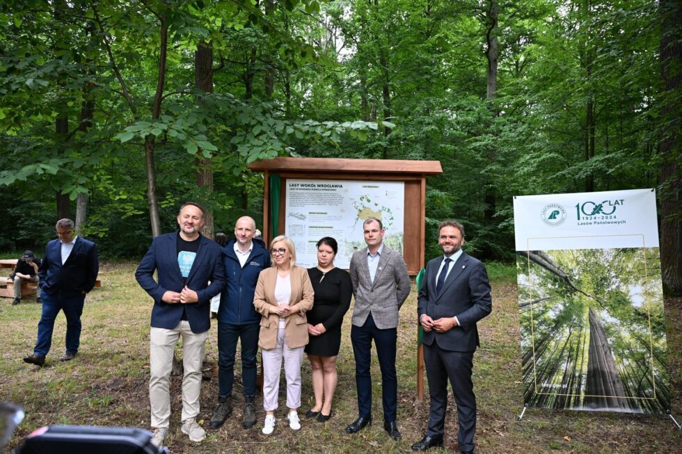 Officials and dignitaries gather at a community forest inauguration ceremony in Poland