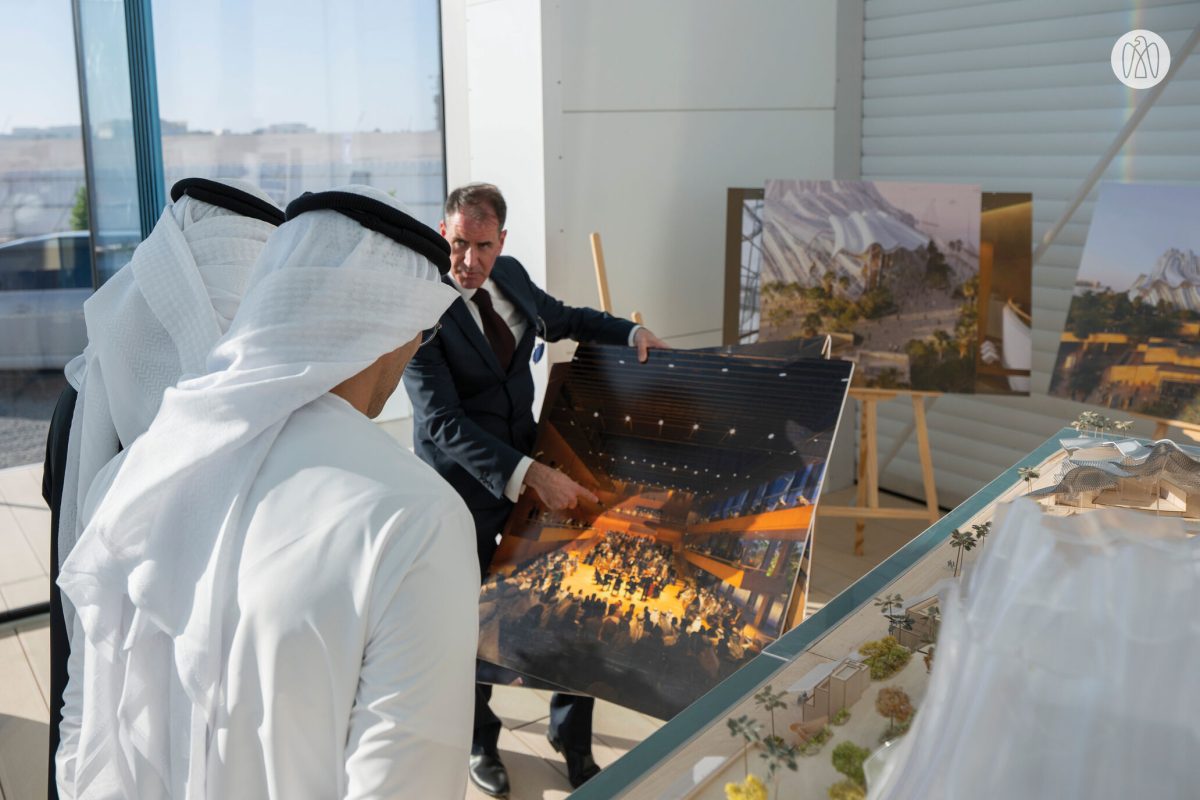 Officials examining architectural model of Frank Gehry's performing arts centre design