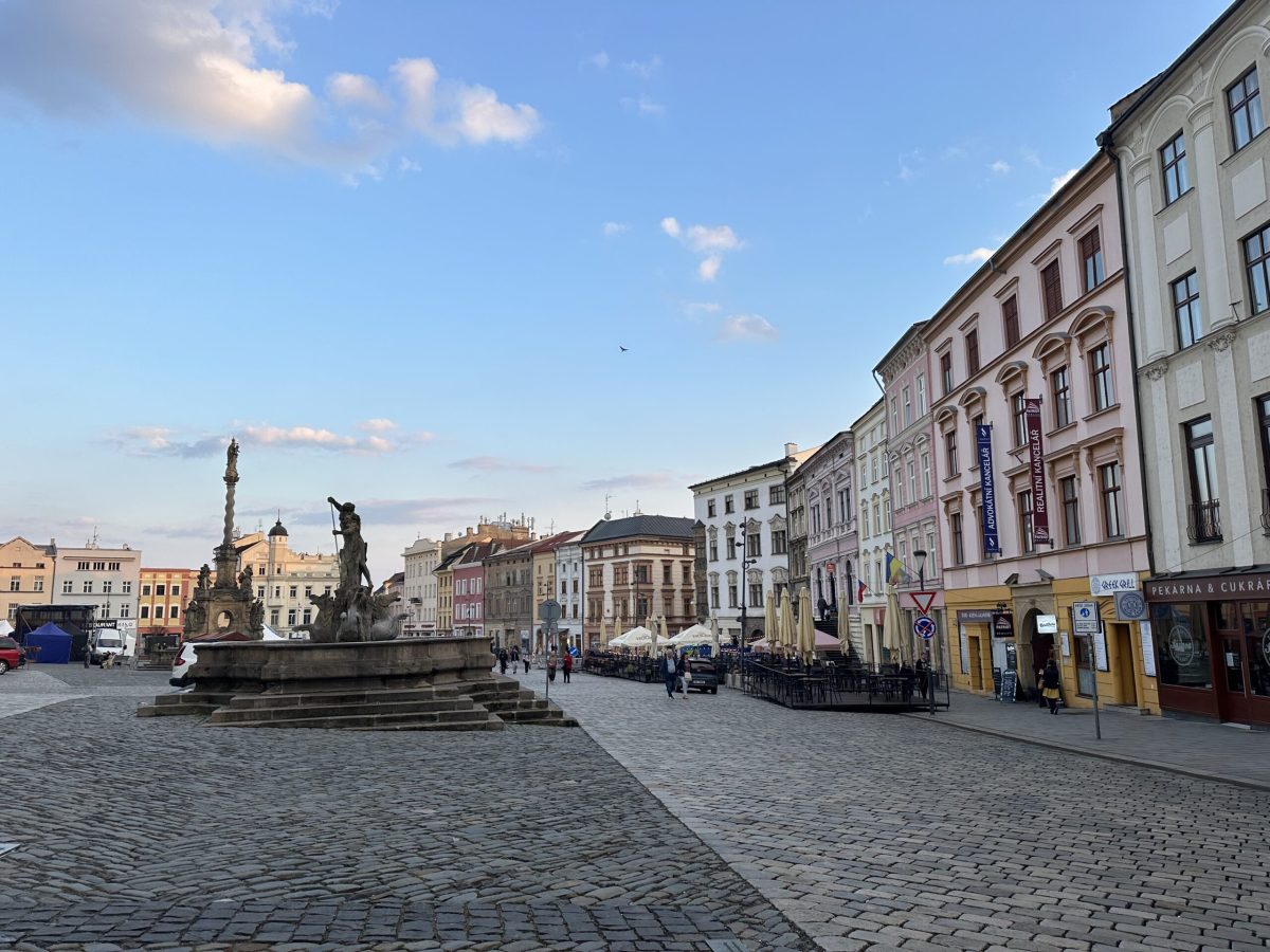 Olomouc's historic main square with fountain and colorful baroque buildings