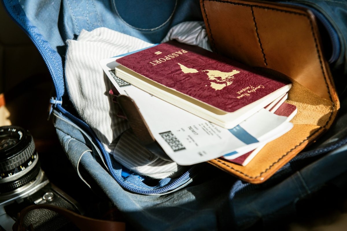 Open travel bag containing passport and documents