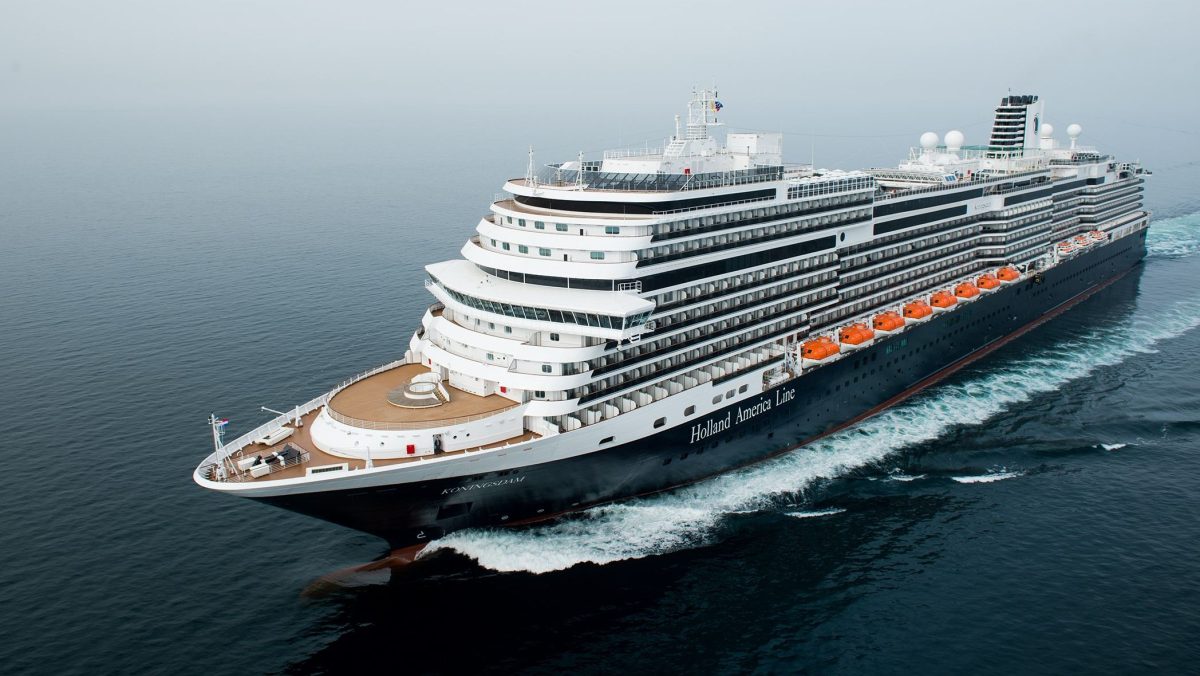 Holland America Line cruise ship sailing through calm waters.