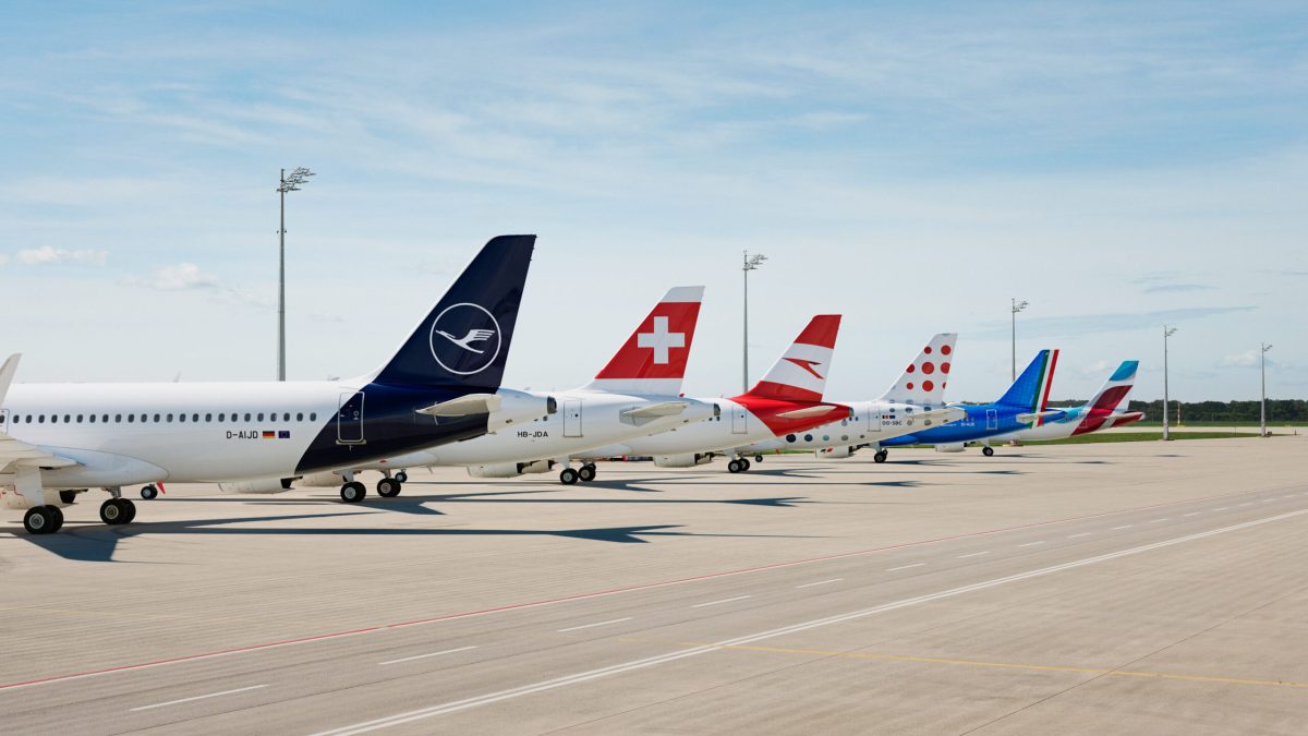 Parked aircraft including Lufthansa and Swiss planes at airport terminal