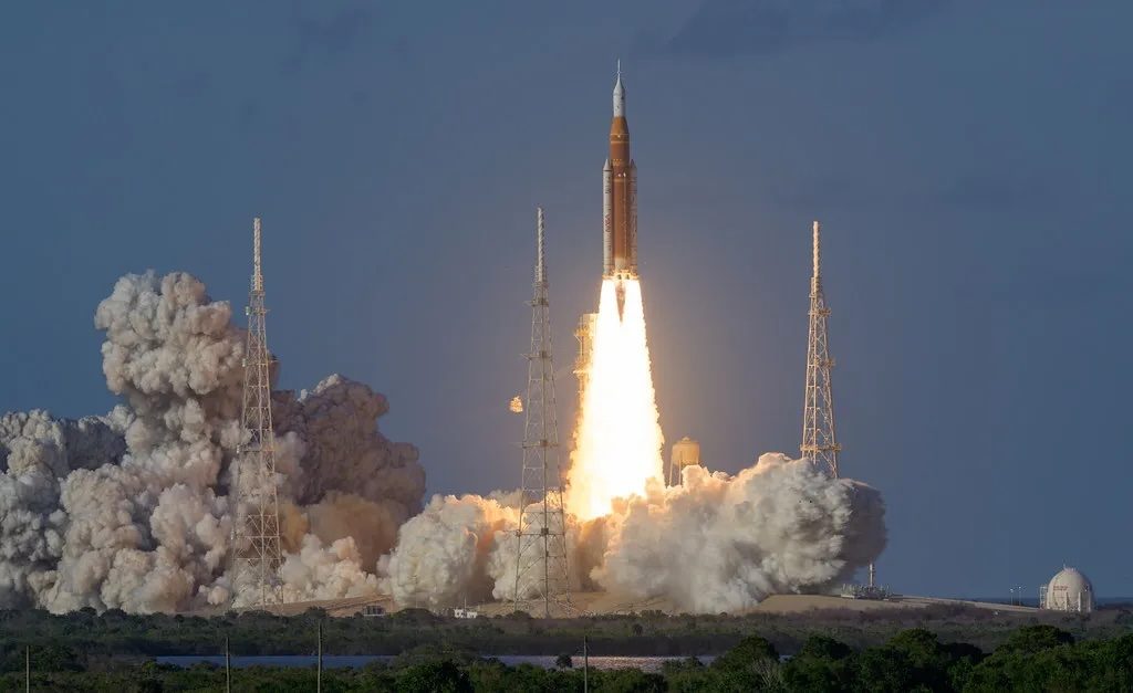 NASA's Space Launch System rocket lifts off from Kennedy Space Center with massive plumes of smoke and flame