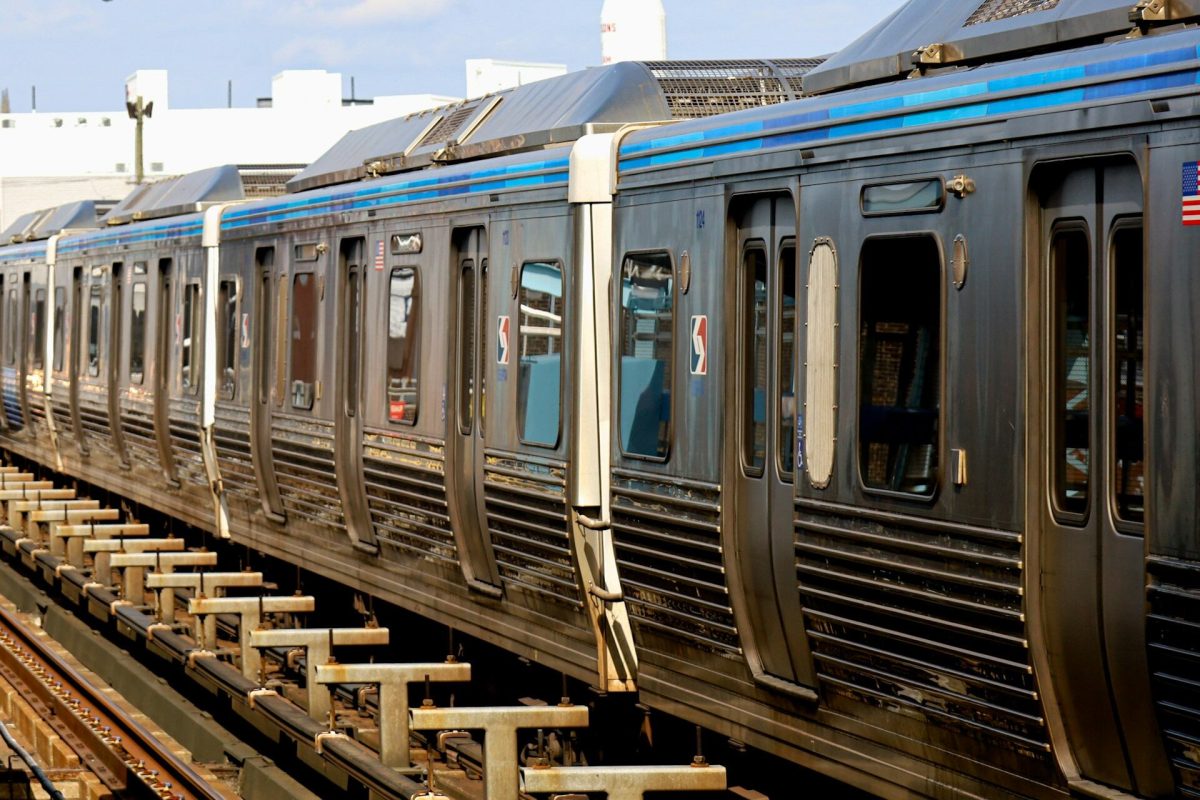 Blue and silver commuter train cars lined up on multiple tracks