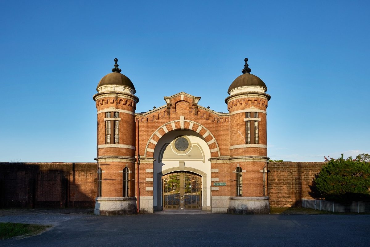 Red-brick Victorian gatehouse with twin domes and arched entrance of historic Nara prison