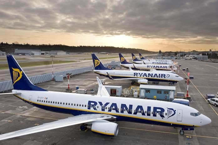 Multiple Ryanair aircraft parked at airport terminal during overcast conditions