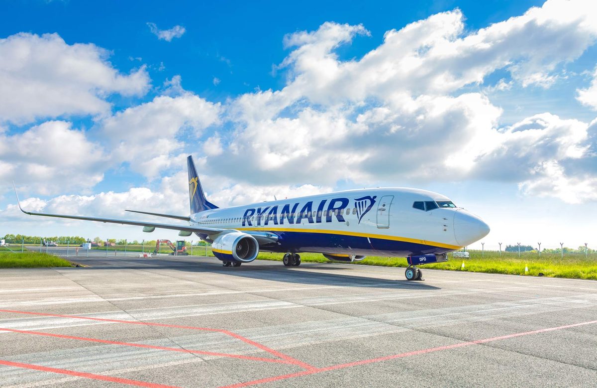 Ryanair Boeing 737 aircraft parked on airport tarmac under blue sky
