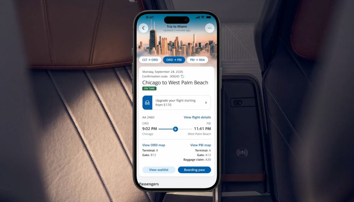 Smartphone displaying American Airlines app with flight details in a car.