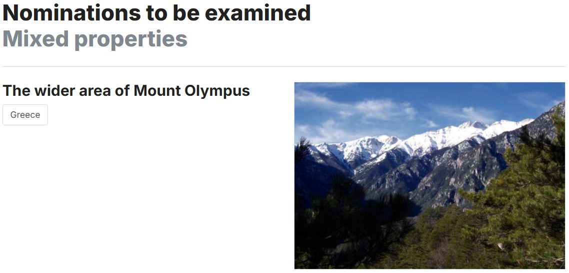 Snow-capped Mount Olympus peaks with forested slopes under blue sky