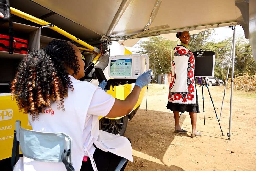 Solar-powered ambulance being tested at a remote rural location with staff and patient