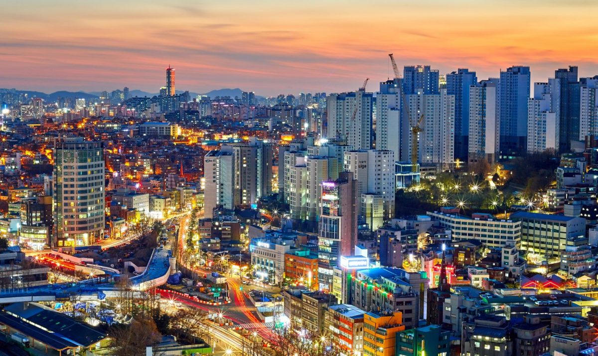 Seoul cityscape at dusk with illuminated skyscrapers and neighborhoods