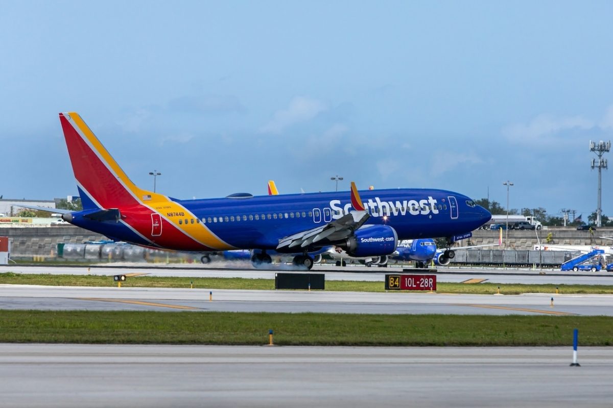 Southwest Airlines Boeing 737 aircraft on airport tarmac with blue fuselage and red/yellow livery