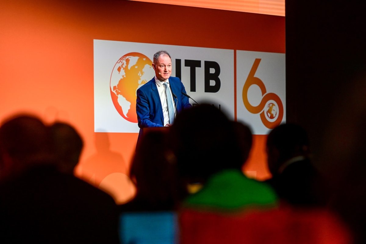 Speaker presenting at ITB Berlin 2026 conference with ITB logo and 60th anniversary branding