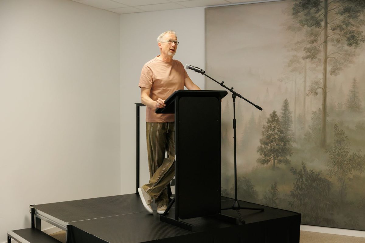 Speaker presenting at podium about sustainable tourism initiative in Belgium