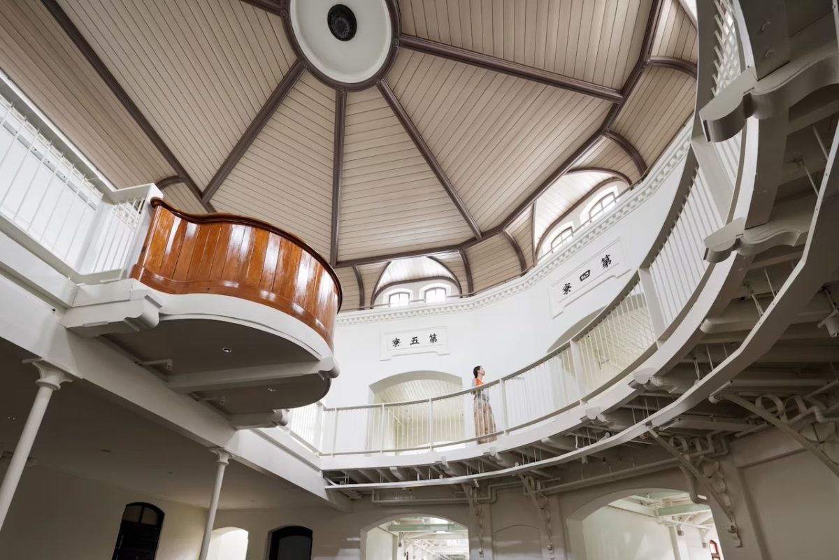 Spiral staircase in HOSHINOYA Nara Prison Hotel with wooden railings and domed ceiling