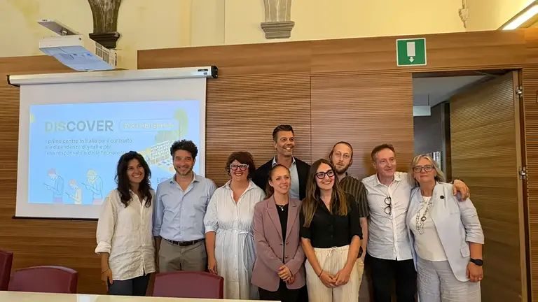 Team members at the Discover digital addiction centre in Florence stand together after presentation