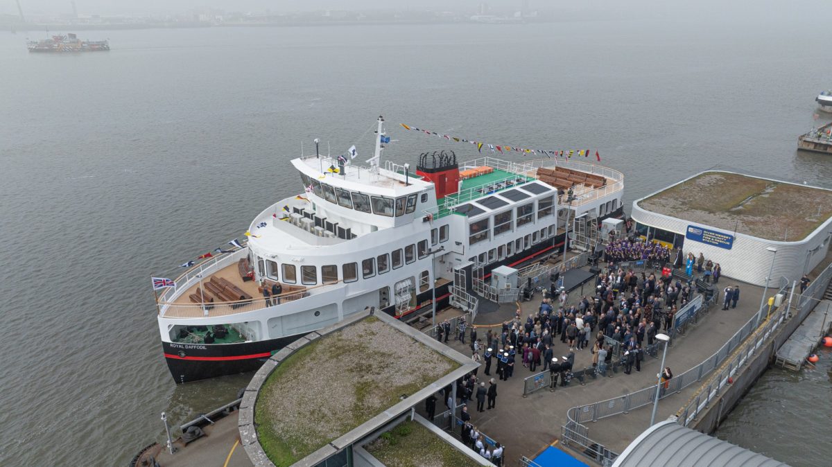 The Royal Daffodil ferry docked at a terminal, with passengers on board.