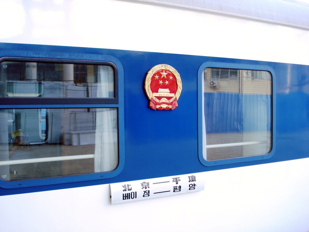 Blue train car with Chinese national emblem and Beijing-Pyongyang route marking