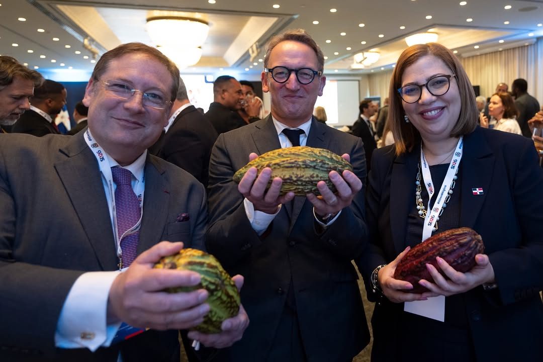 Three business representatives holding cacao pods at Dominican Republic economic event in Brussels