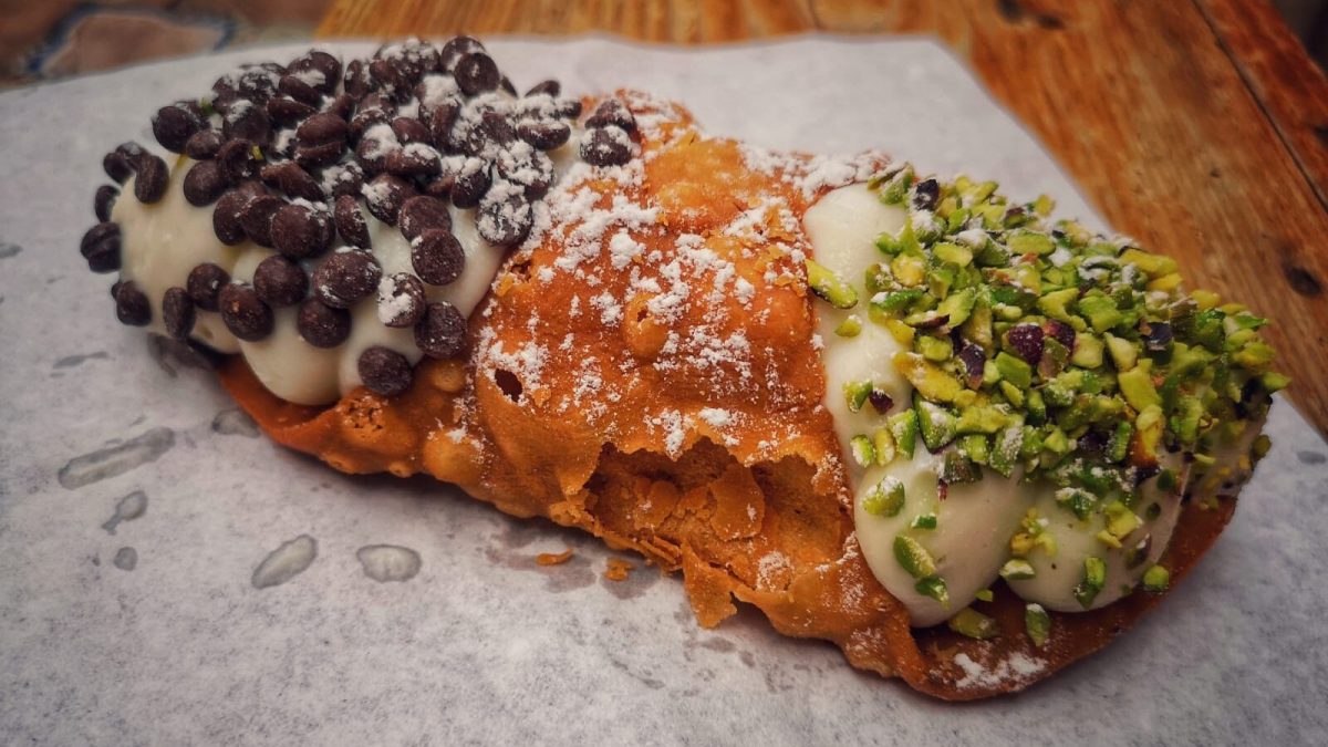 Three pastries with different toppings: chocolate chips, powdered sugar, and pistachio garnish