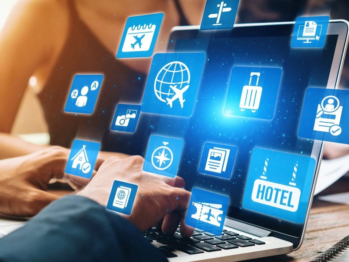 Digital travel icons floating above laptop screen showing tourism booking and management tools