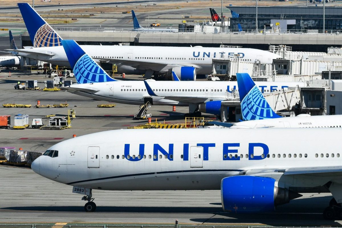 Multiple United Airlines aircraft parked at airport gates showing blue and white livery